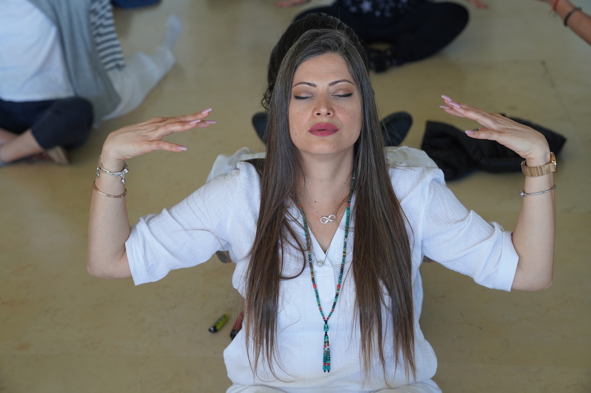 "Participants engaging in morning meditation at Tao Rehab Thailand in a peaceful outdoor setting."