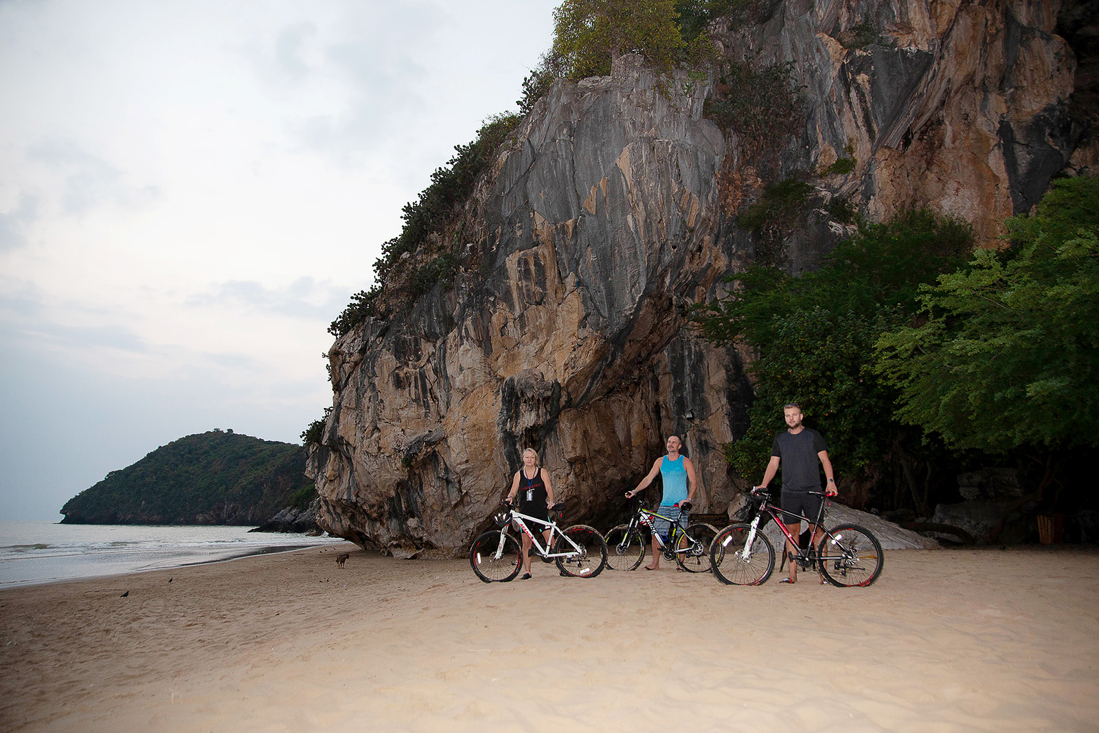 "Group on a bike tour exploring the scenic surroundings of Tao Rehab Thailand."